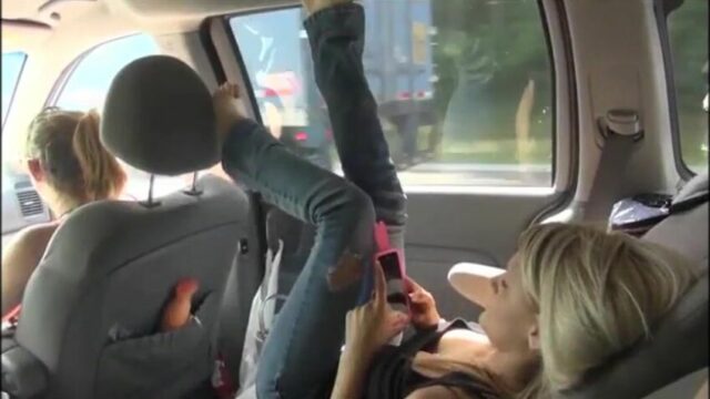 Blonde girl gives sneaky backseat car blowjob